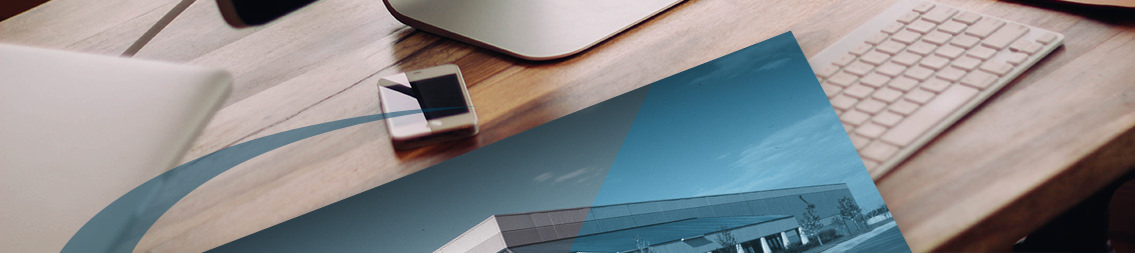 Brochure, desk, keyboard and mobile phone.